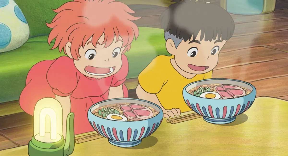 Two kids stare excitedly into steaming bowls of ramen in "Ponyo"
