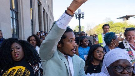 State Rep. Justin Jones of Nashville raises his fist after being reinstated to his seat.