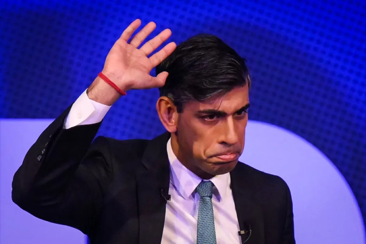 British Prime Minister Rishi Sunak reacts and waves after delivering a speech on stage as he hosts a Business Connect event on April 24, 2023 in London, England.