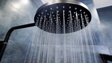 Water running from a black showerhead