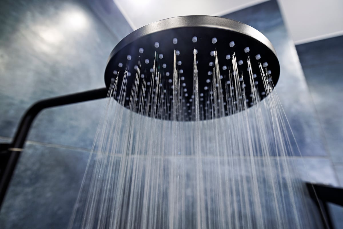 Water running from a black showerhead