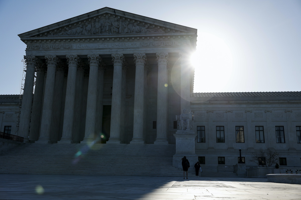 The sun rises behind the Supreme Court building.