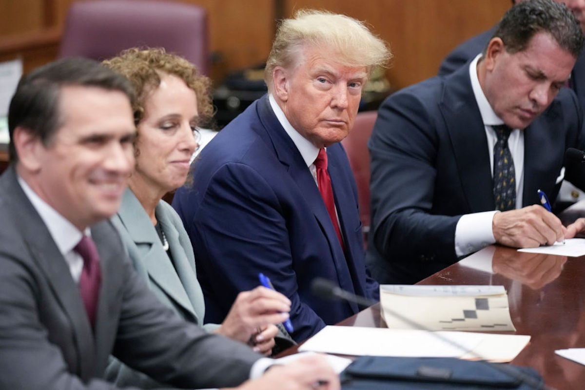 Flanked by attorneys, former U.S. President Donald Trump appears in the courtroom