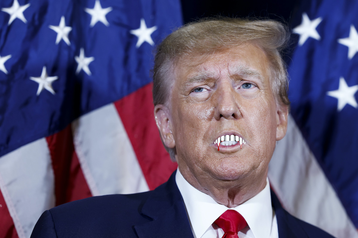A photo of Donald Trump with vampire teeth superimposed.