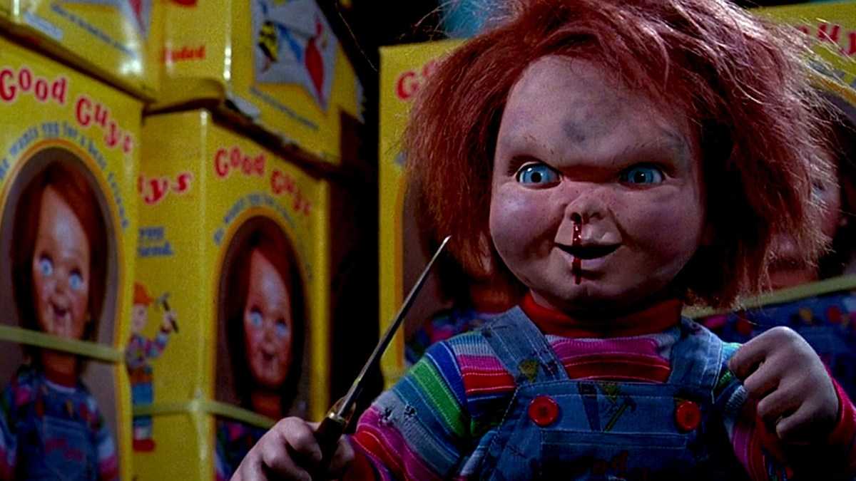 Chucky holding a knife and bleeding from his nose in Child's Play