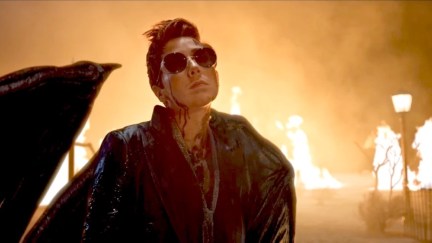 Hillywood Show Good Omens parody featuring Crowley the demon standing in front of flames.