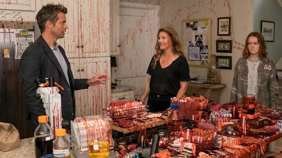 The Hammond family standing around in their incredibly messy kitchen in Santa Clarita Diet