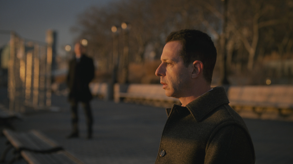 Kendall Roy (Jeremy Strong) sits on a bench, looking out at the water in the series finale of 'Succession'