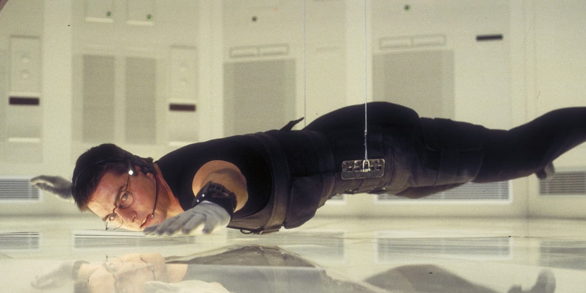 Tom Cruise as Ethan Hunt, suspended from a wire in the first Mission: Impossible movie 