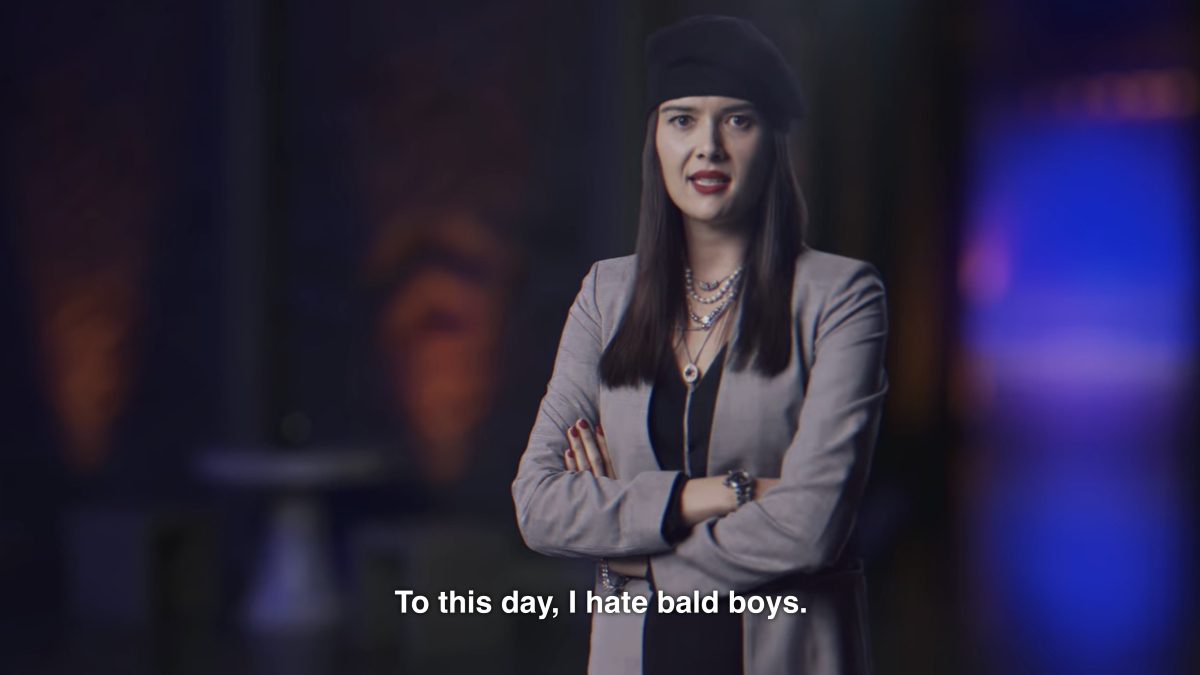 Patti Harrison stands with arms folded, wearing a beret in 'I Think You Should Leave.' The subtitle reads "To this day, I hate bald boys."