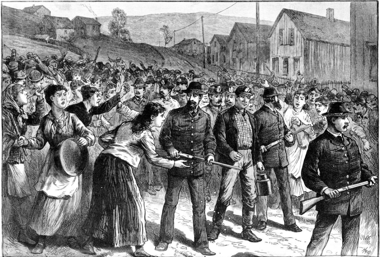 Pinkerton guards escorting scabs during a 1884 miners strike in Buchtel Ohio.