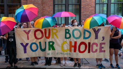 Pro-choice protesters hold up a sign that reads 