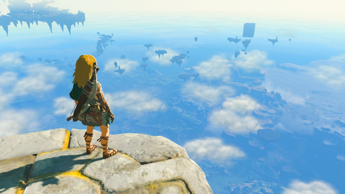 Link stands on a precipice, looking out over a city in clouds in 'The Legend of Zelda: Tears of the Kingdom'