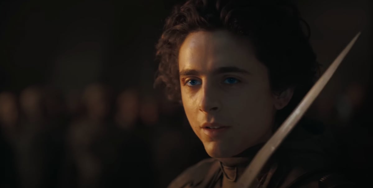 Paul Atreides (Timothee Chalamet) readies his knife as his eyes glow blue in 'Dune: Part Two'