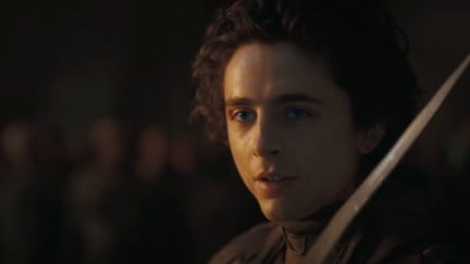 Paul Atreides (Timothee Chalamet) readies his knife as his eyes glow blue in 'Dune: Part Two'