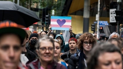 A group of trans rights protesters march.