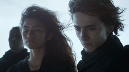 Chani (Zendaya) and Paul (Timothee Chalamet) gaze upon his legion of supporters as their eyes glow blue in one of Paul's visions from the first 'Dune' movie