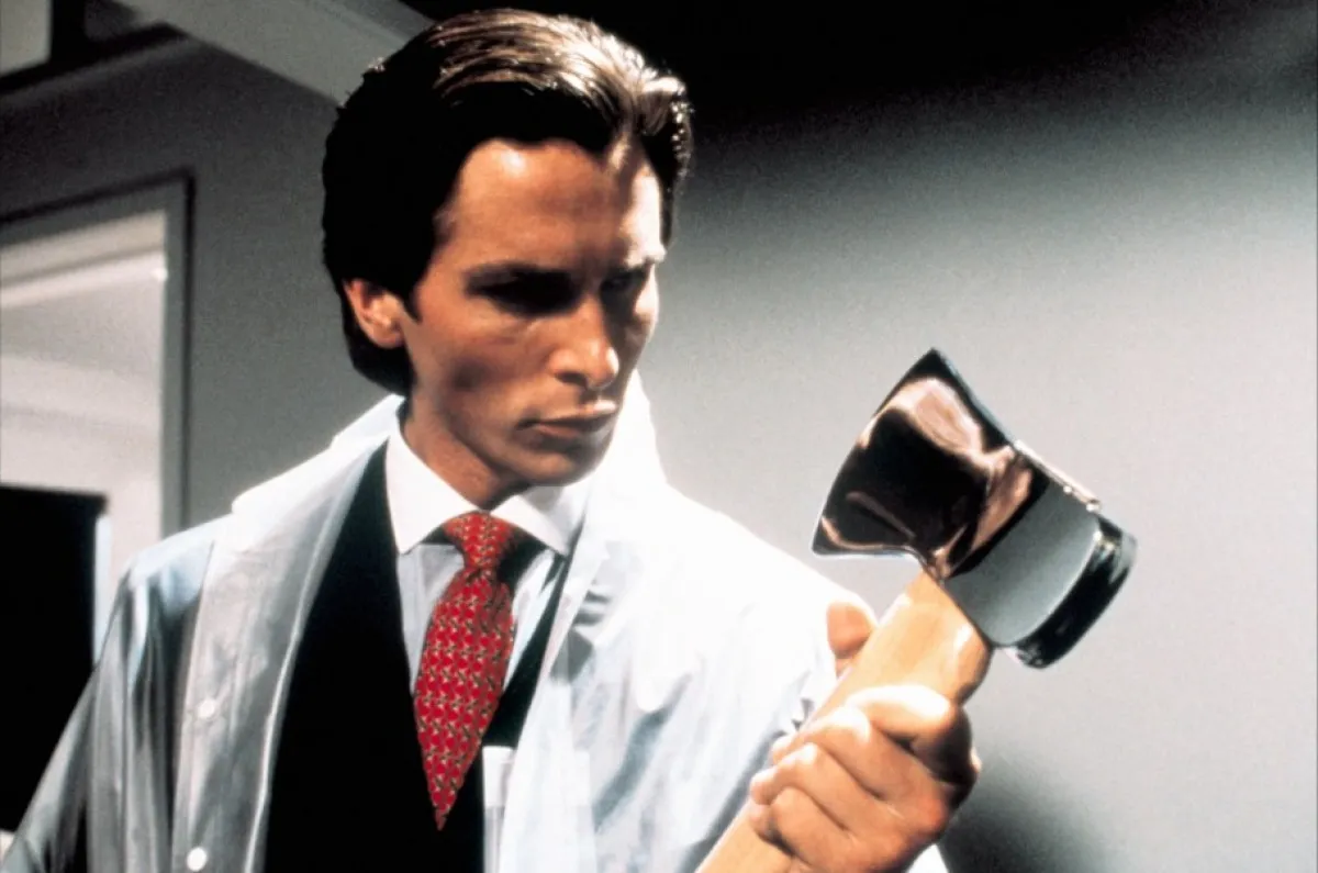 A wall street business man wrapped in plastic contemplates an axe in "American Psycho"