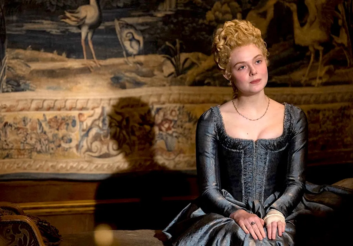 Elle Fanning as Catherine the Great in Hulu's The Great. She sits pensively.