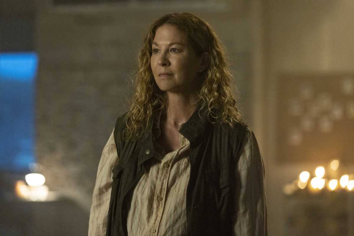 Jenna Elfman as June, with fires burning behind her, in AMC's Fear the Walking Dead.