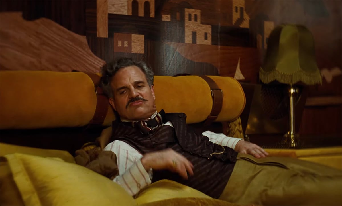 Mark Ruffalo sitting on a couch in 'Poor Things'
