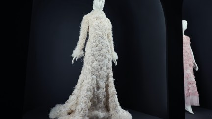 An elaborate white goen on display on a mannequin.