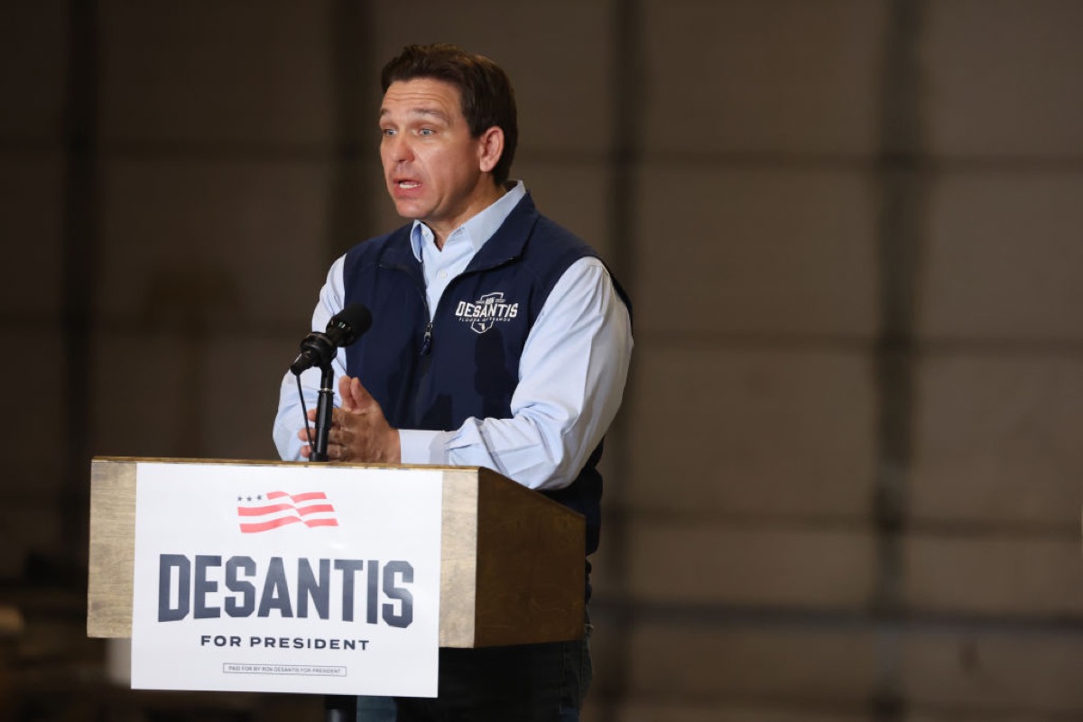 Ron DeSantis, speaking at a podium and looking like the doofus he is.