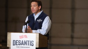 Ron DeSantis, speaking at a podium and looking like the doofus he is.
