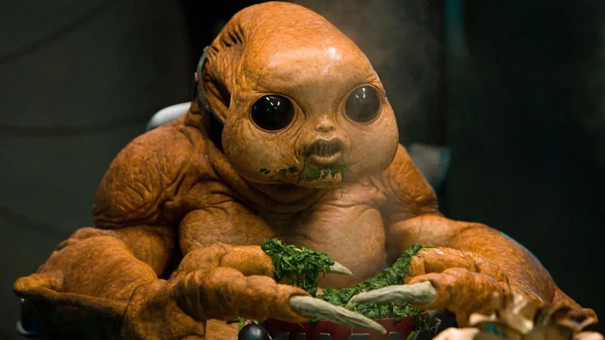 A baby slitheen, a blobby brown creature with claws and big dark eyes.