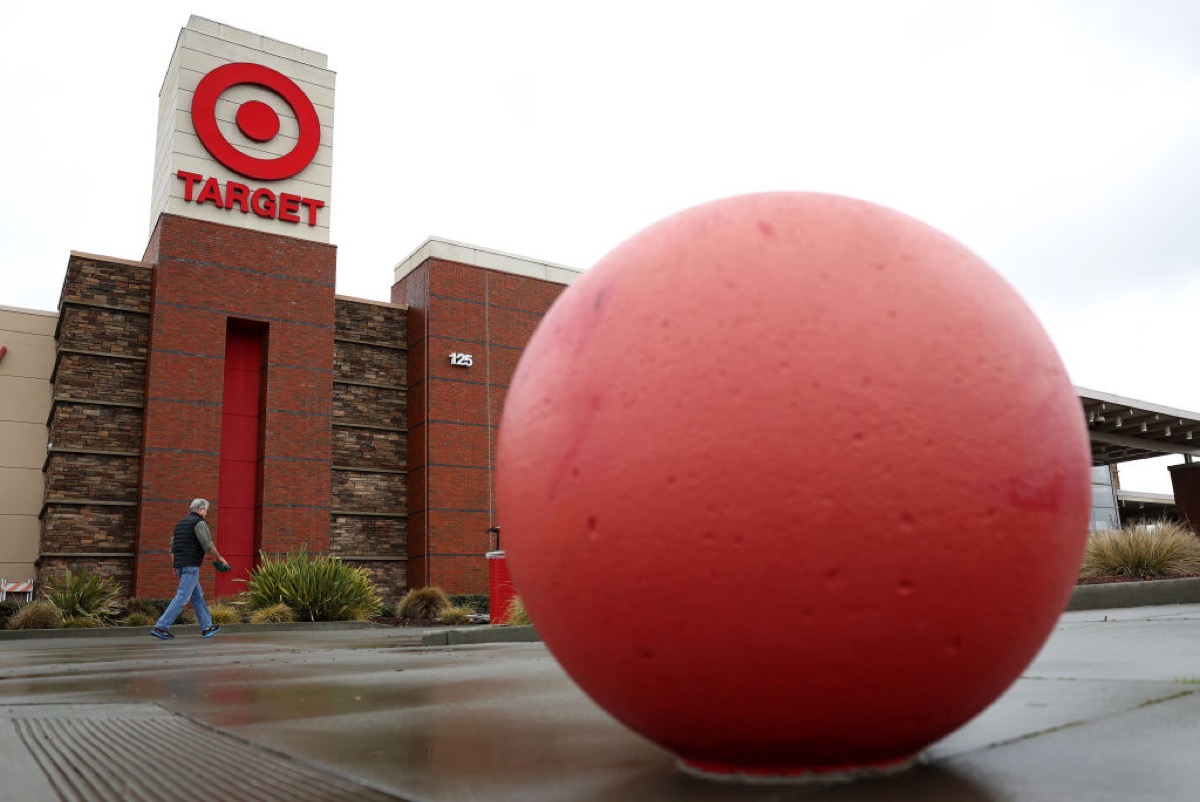 A Target storefront looms over one of the store's giant red sphere decorations.