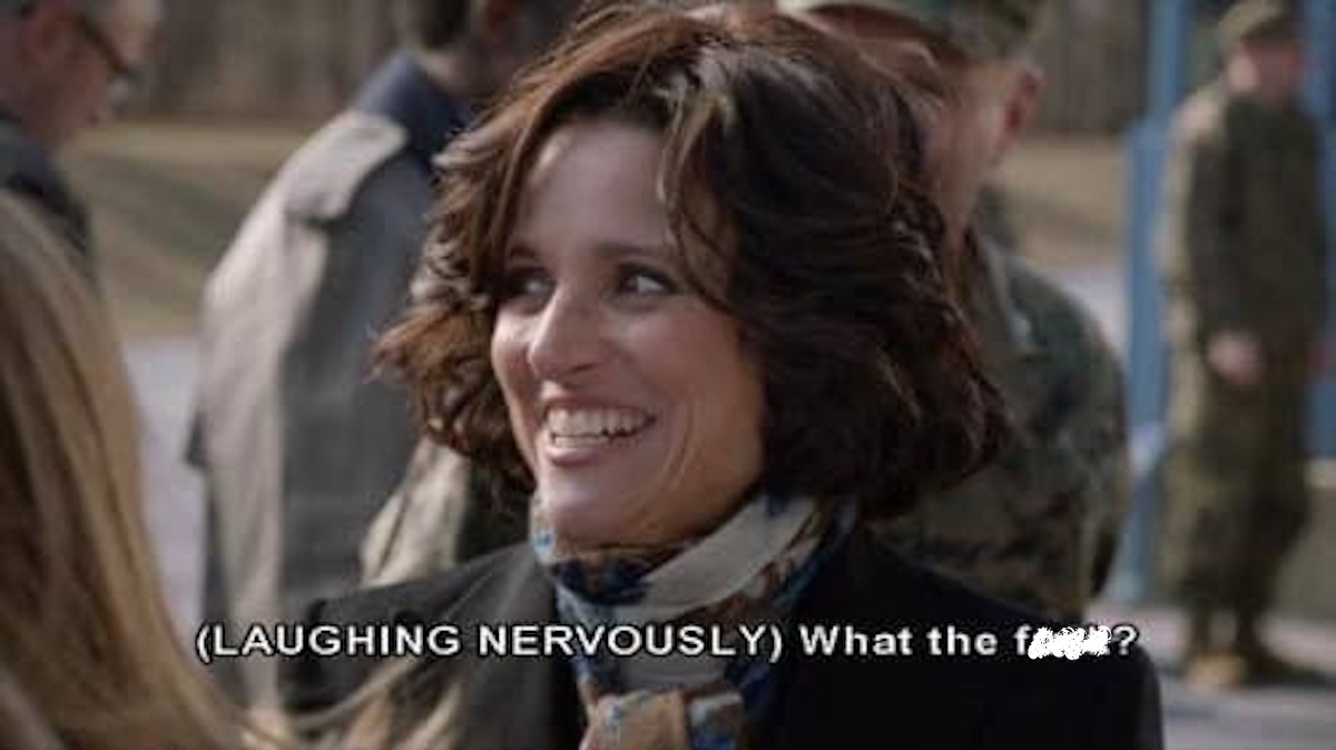 In a scene from Veep, Selina Meyers laughs nervously.