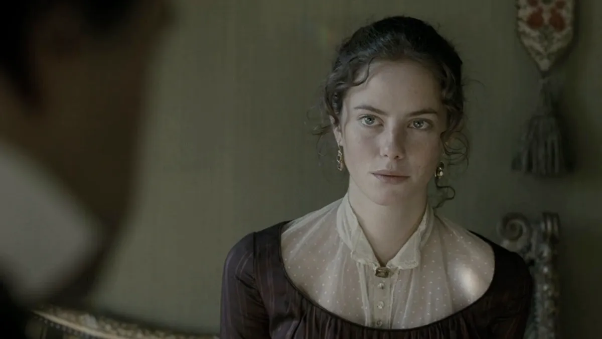 A young woman gazes cautiously at an offscreen person in "Wuthering Heights" 