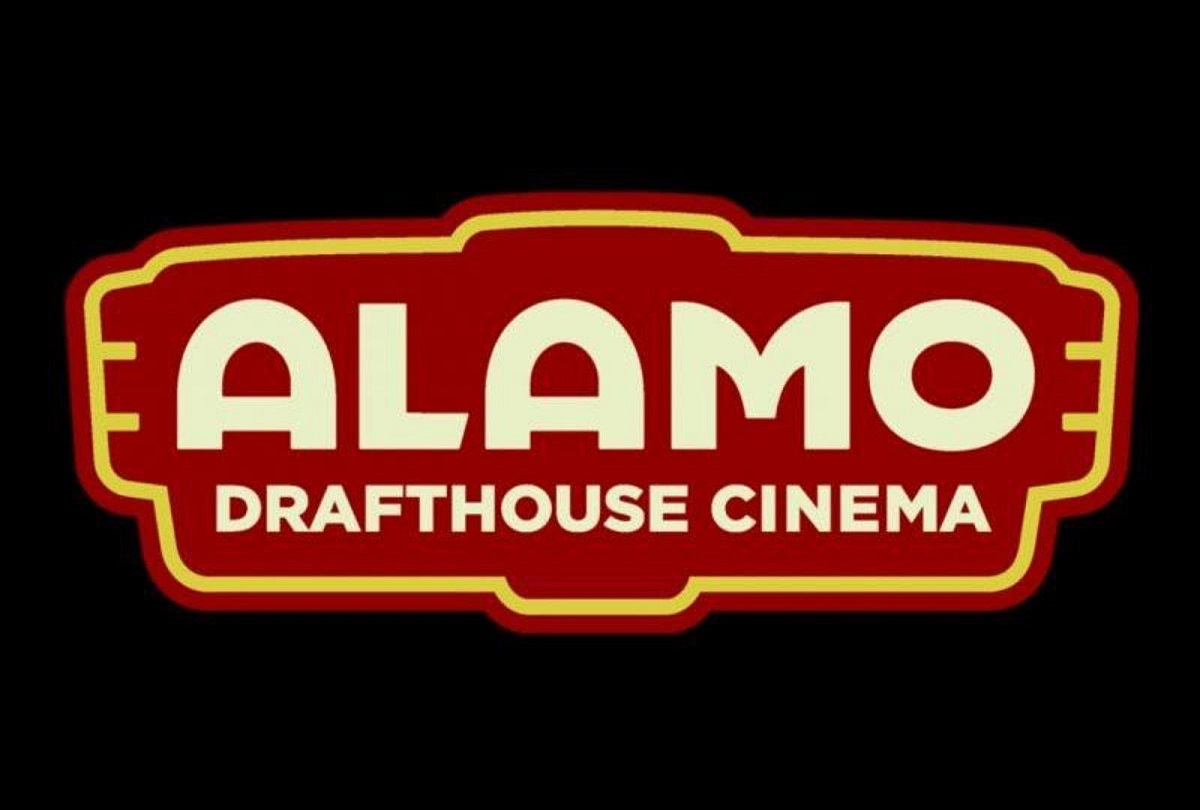 The Alamo Drafthouse Cinema logo. The words are in white on a red logo outlined in yellow, and the whole thing is on a black background.