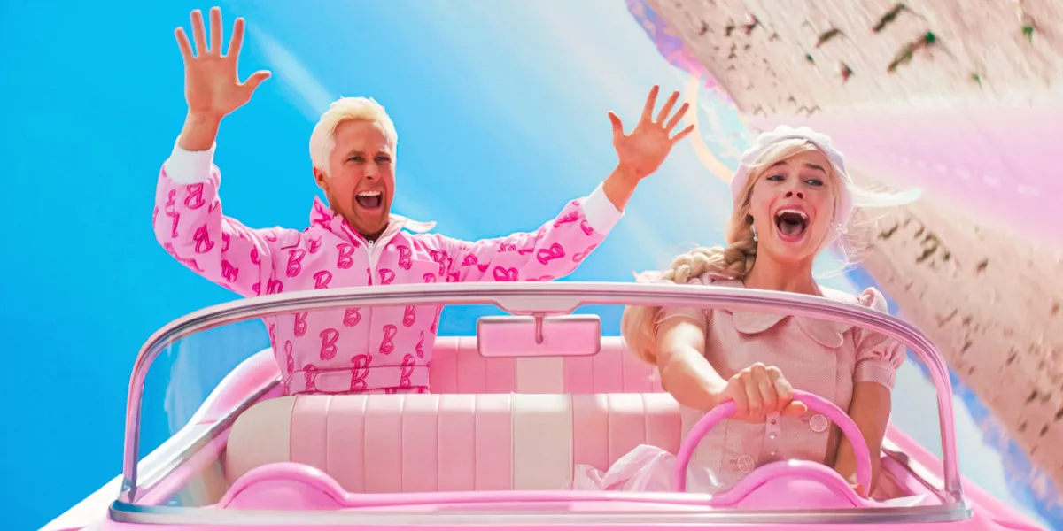 Ryan Gosling as Ken and Margot Robbie as Barbie flying through the air in Barbie's car in the Barbie movie