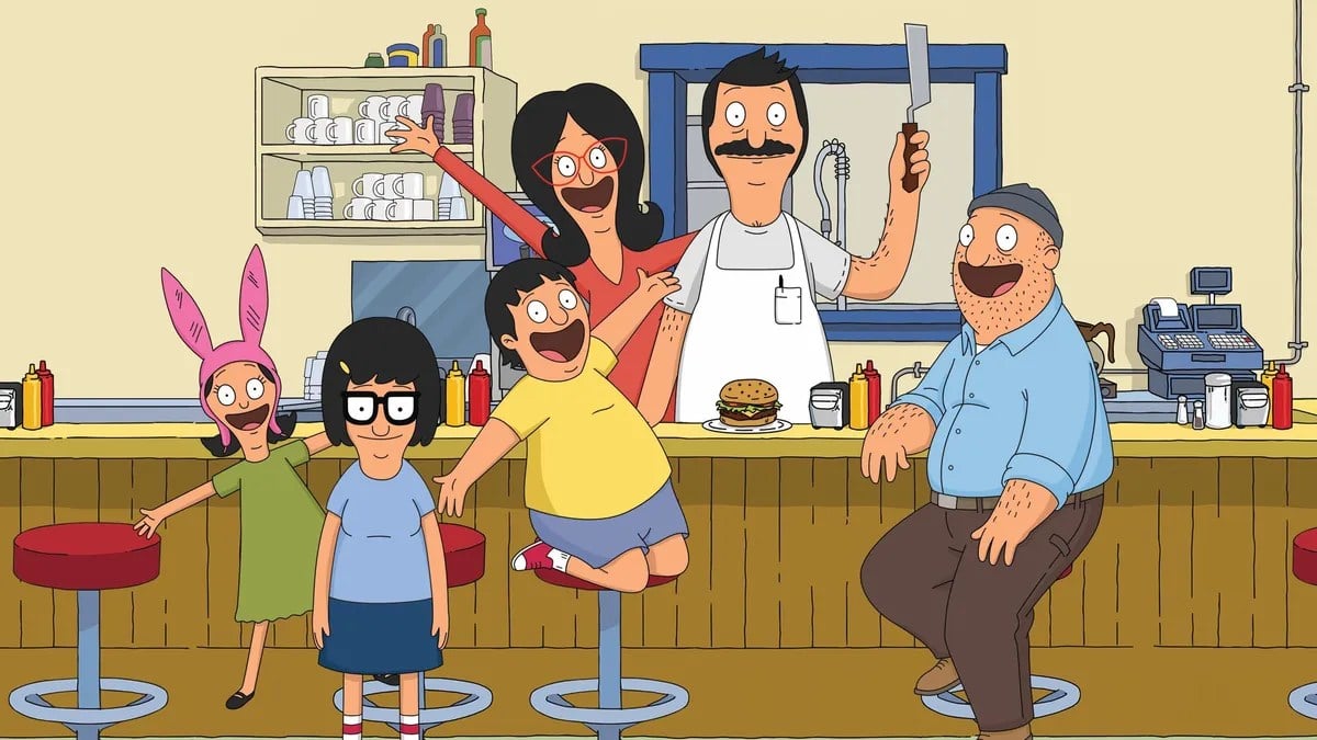 The cast of FOX's animated series 'Bob's Burgers.' (l-r): Louise (Kristen Schaal), Tina (Dan Mintz), Gene (Eugene Mirman), Linda (John Roberts), Bob (H. Jon Benjamin), and Teddy (Larry Murphy) sit at and stand behind the counter in the family diner. 
