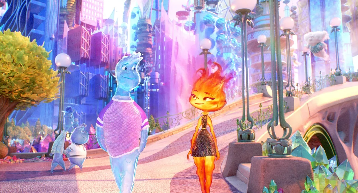 A scene from Pixar's animated film, 'Elemental.' Wade, a male-coded water element walks down a street alongside Ember, a female-coded fire element. They look at each other lovingly.