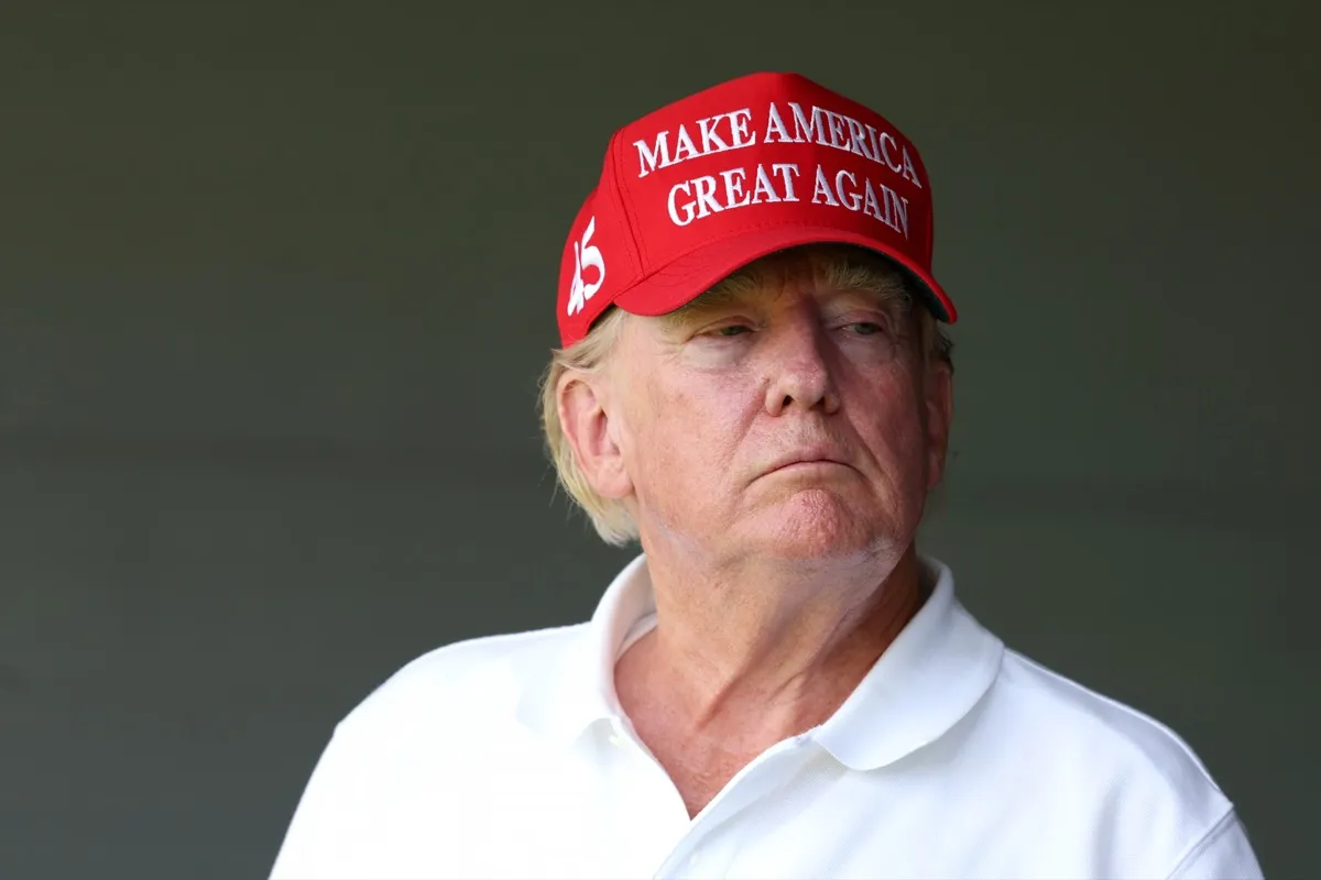 Former US President Donald Trump watches from a box on the 18th green during day one of the LIV Golf Invitational - DC at Trump National Golf Club on May 26, 2023 in Sterling, Virginia.