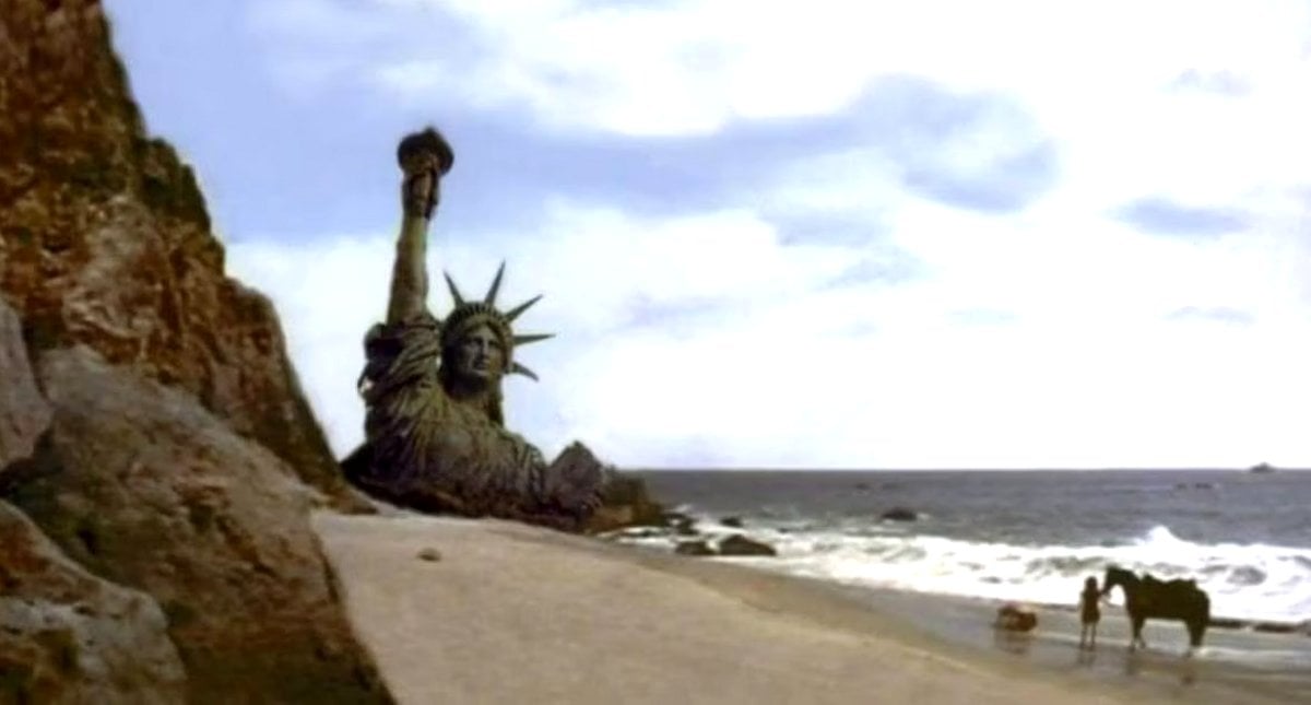 The Statue of Liberty buried in sand at the end of Planet of the Apes (20th Century Fox)