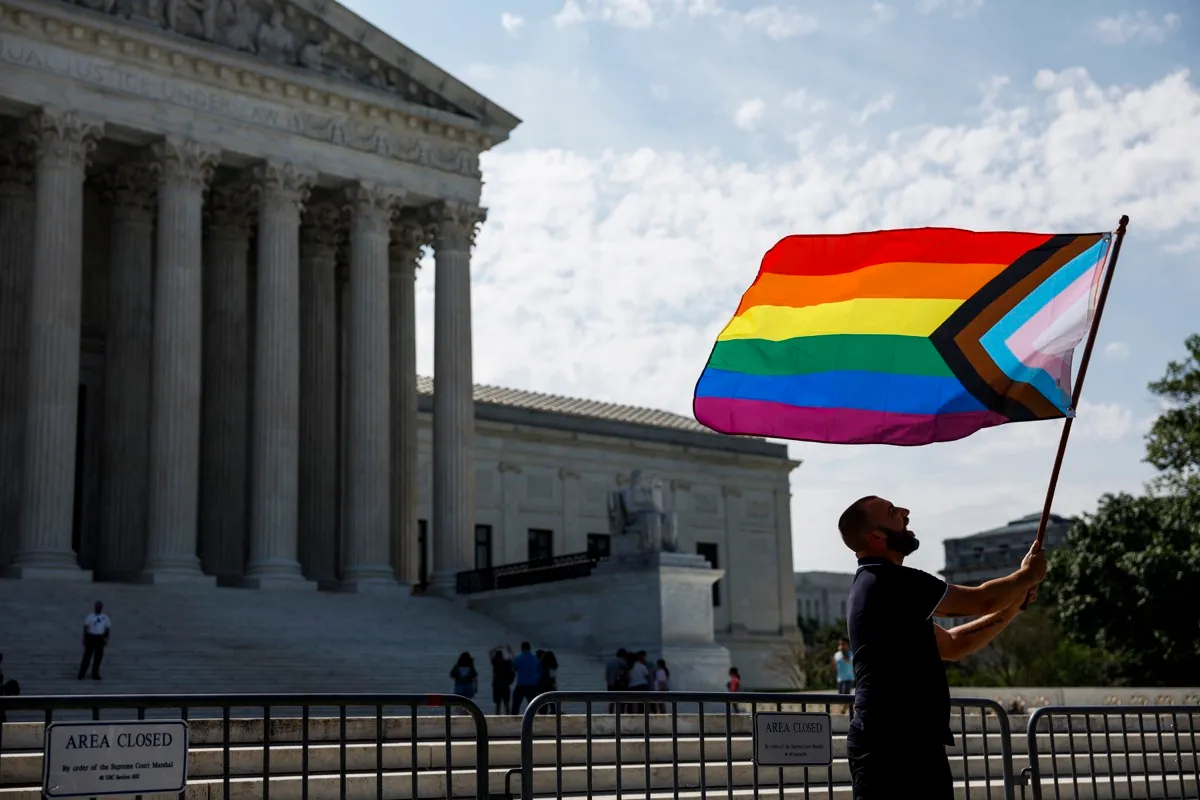Same-sex marriage supporter Vin Testa, of Washington, DC, waves a LGBTQIA pride flag in front of the U.S. Supreme Court Building as he makes pictures with his friend Donte Gonzalez to celebrate the anniversary of the United States v. Windsor and the Obergefell v. Hodges decisions on June 26, 2023 in Washington, DC. (Photo by Anna Moneymaker/Getty Images)