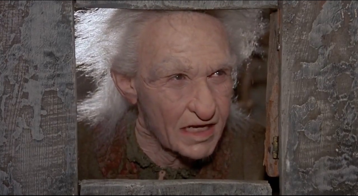 Miracle Max pokes his face through a doorway in The Princess Bride.