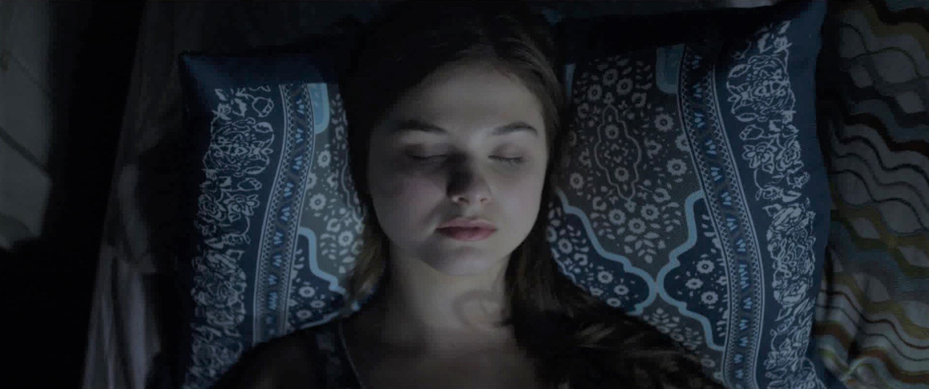 Quinn Brenner sleeping in a bed in Insidious: Chapter 3