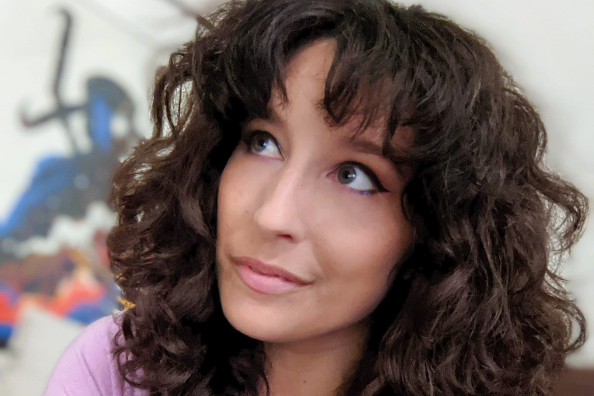 A beautiful young woman (Brittany Knupper) glances upwards.