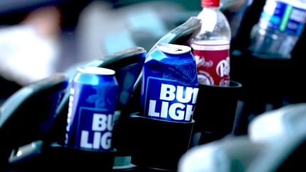 Bud light cans in cupholders. One is crushed.
