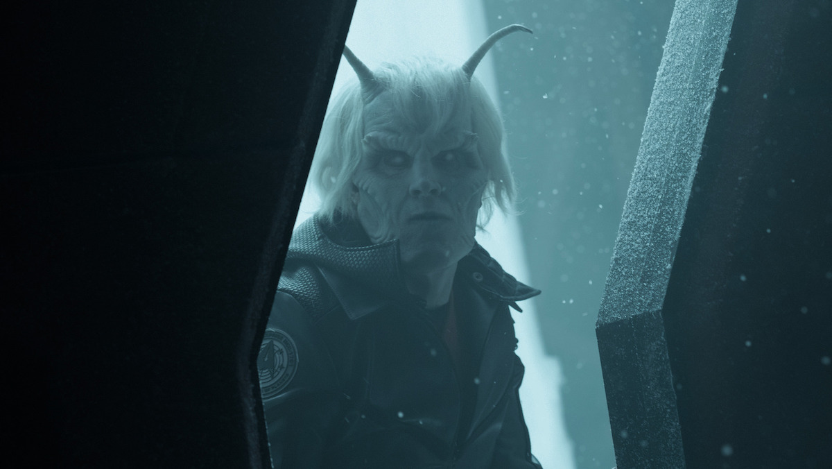 Hemmer looks through a snowy doorway in Star Trek: Strange New Worlds.
