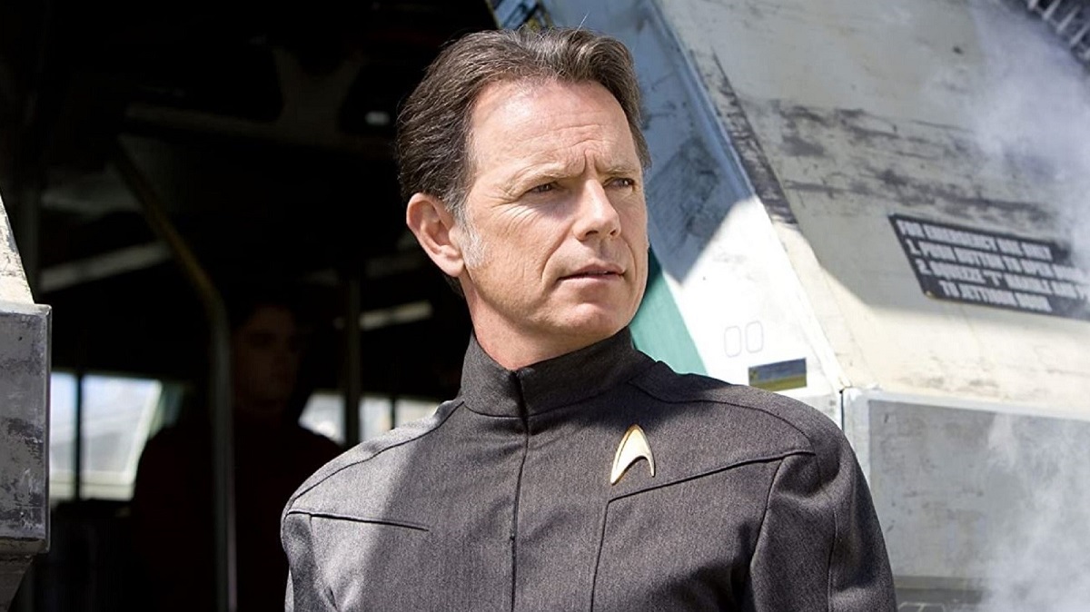 Bruce Greenwood as Captain Pike in a scene from 2009's 'Star Trek.' He is a middle-aged white man with short, brown hair wearing a grey Starfleet uniform.