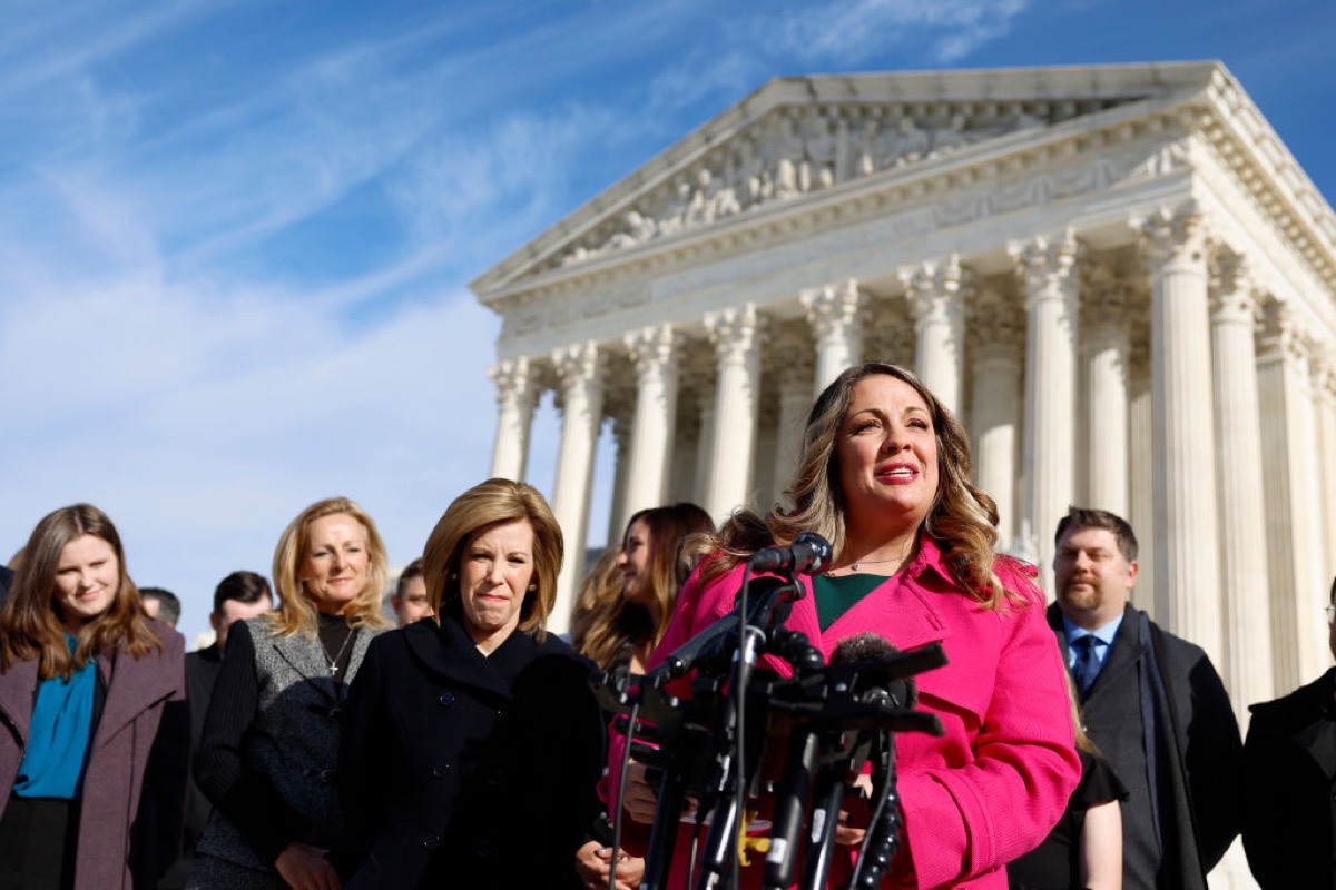 Lorie Smith, the owner of 303 Creative, a website design company in Colorado, speaks to reporters outside of the U.S. Supreme Court Building.