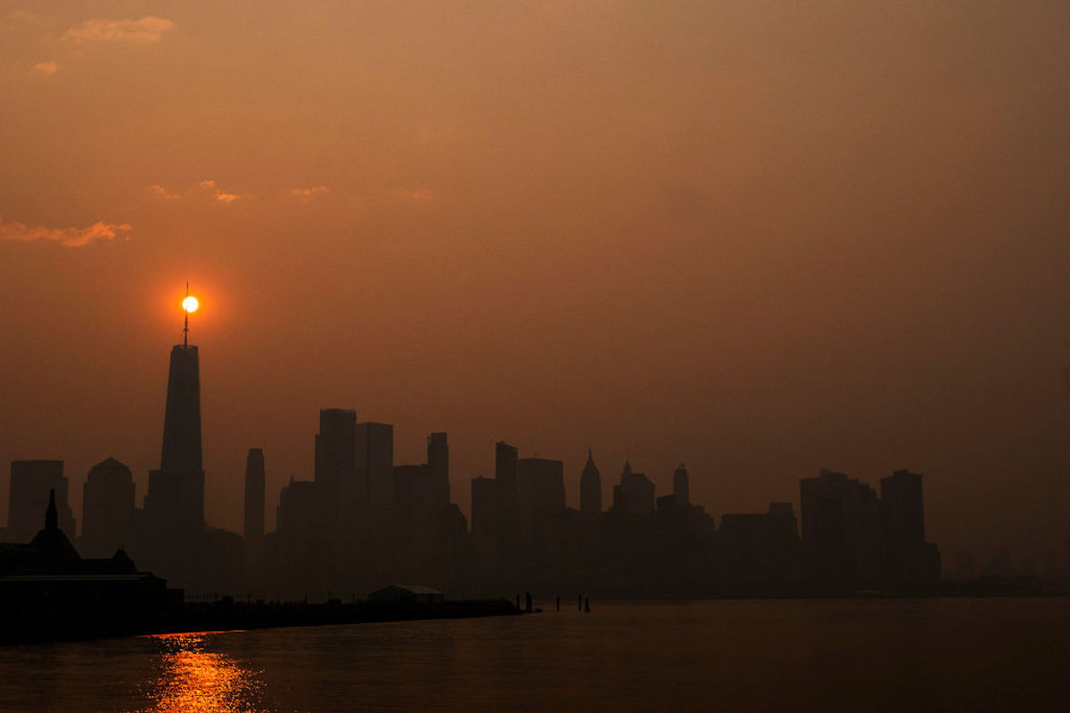 The New York City skyline, with a dark red sky and a bright red sun.