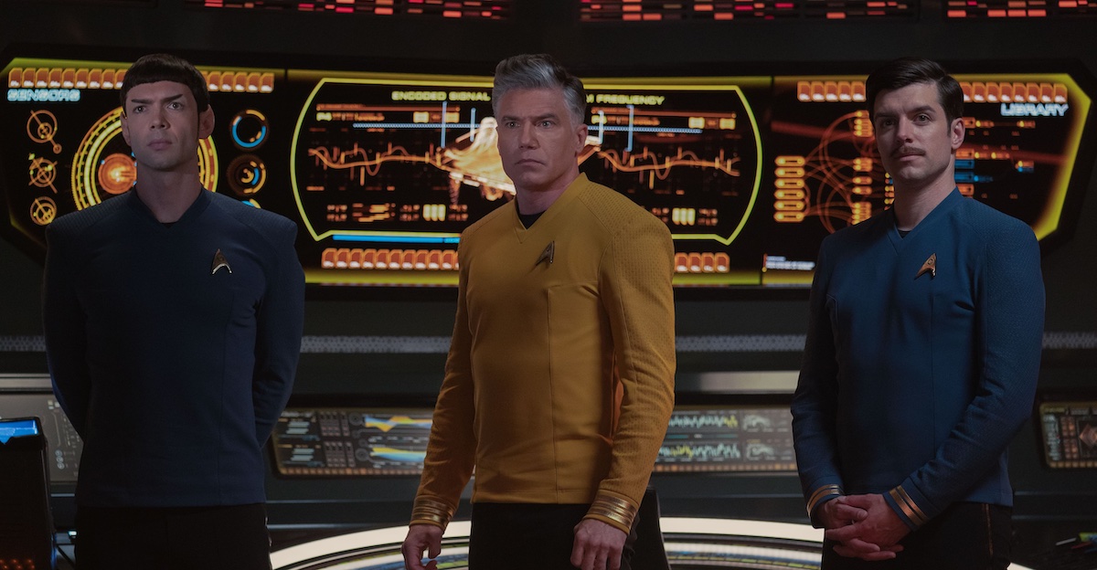 Captain Pike, along with Spock and Sam Kirk stand on the bridge of the Enterprise.