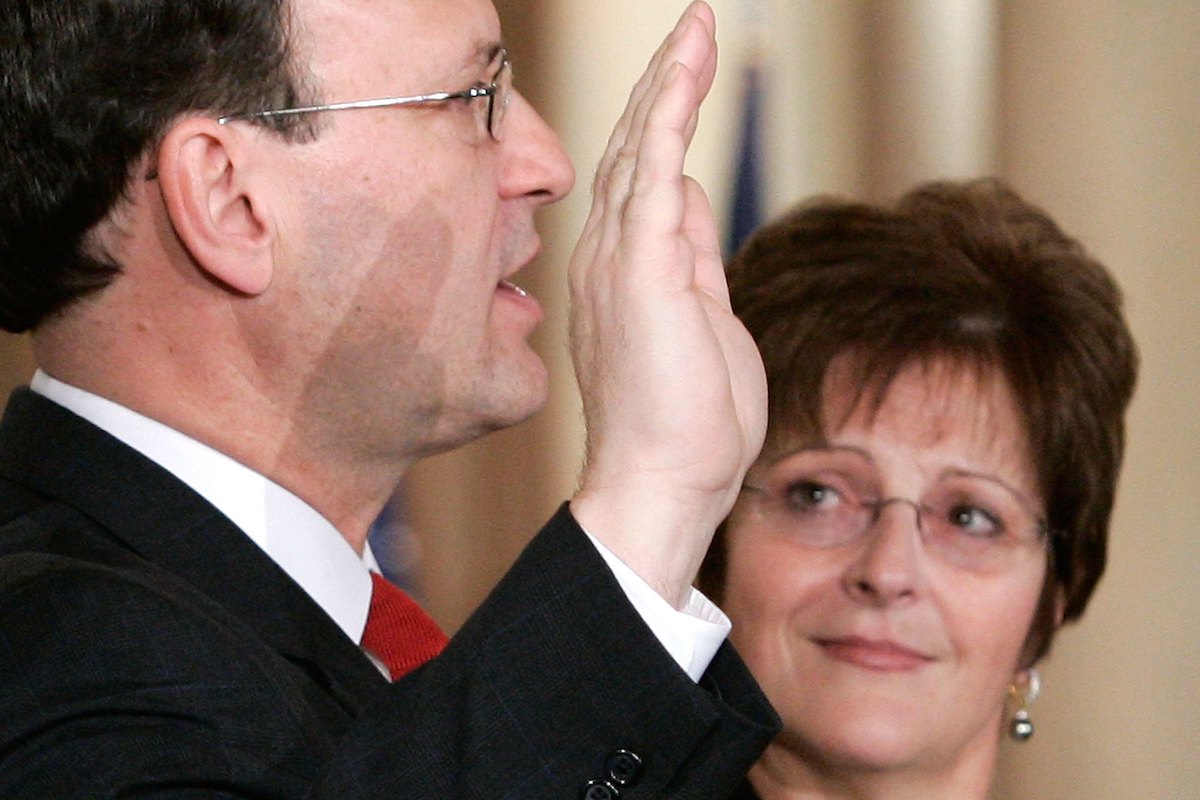 U.S. Supreme Court Justice Samuel Alito (L) is sworn in as his wife Martha-Ann Bomgardner looks on
