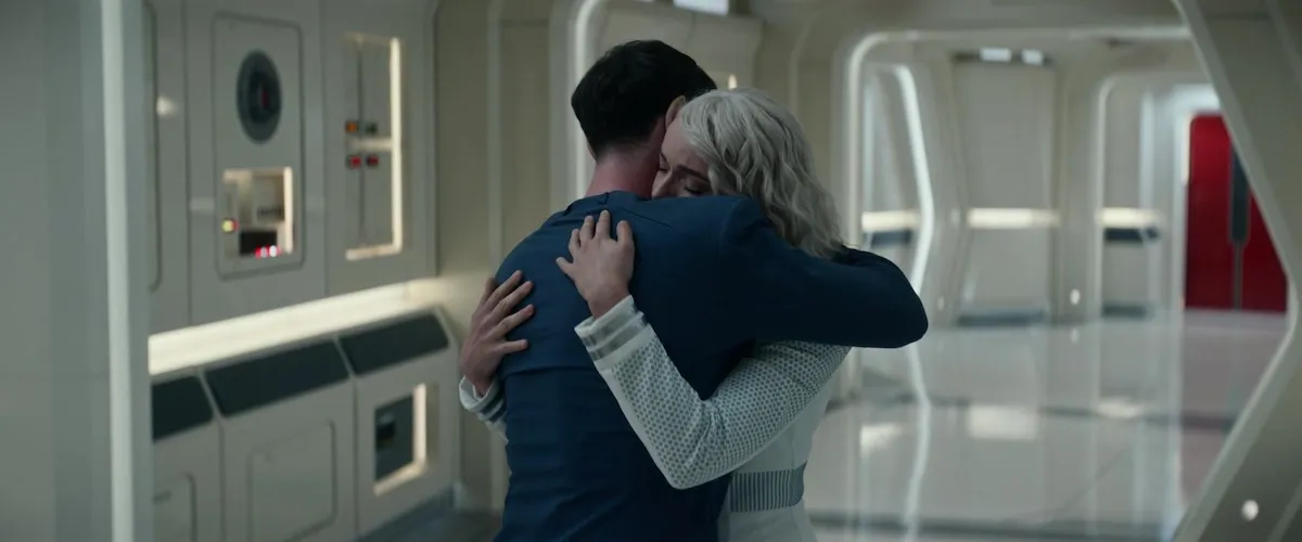 Spock and Chapel share an emotional hug in the hallways of the Enterprise.